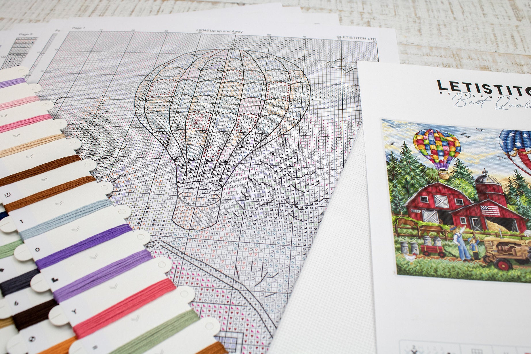 Up Up and Away L8048 Counted Cross Stitch Kit featuring colorful threads, Aida canvas, and detailed instruction chart.